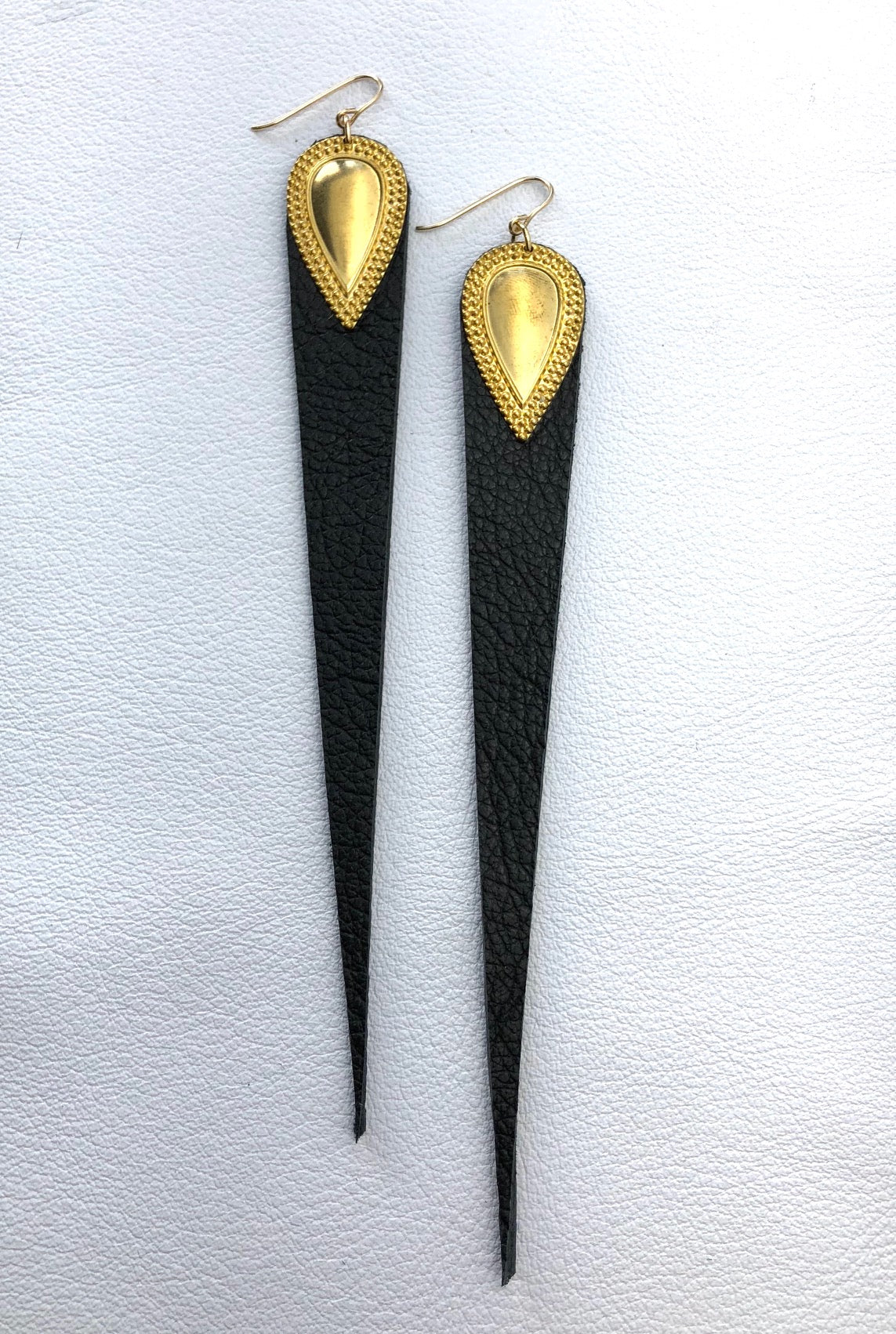 Dramatic length, leather drops.