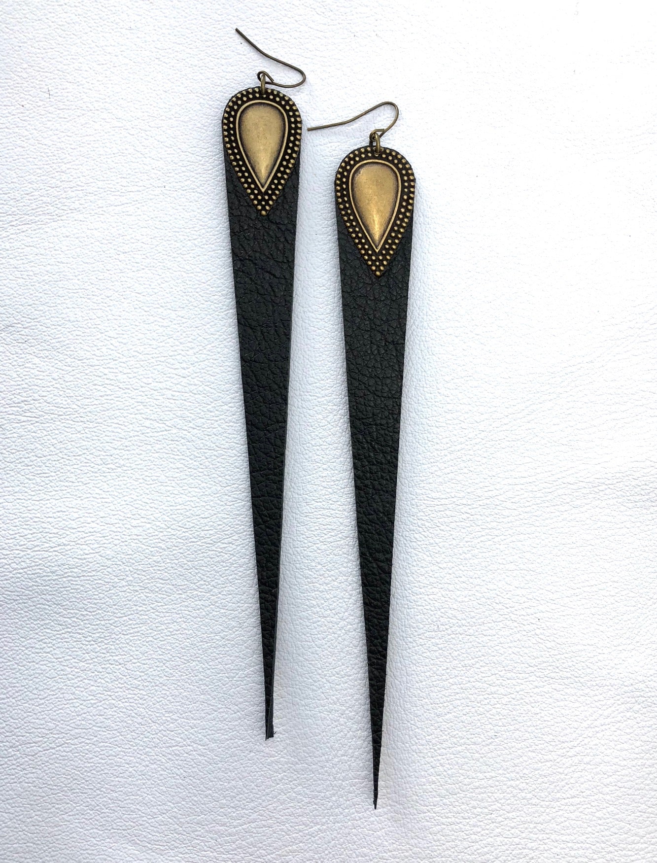 Dramatic length, leather drops.