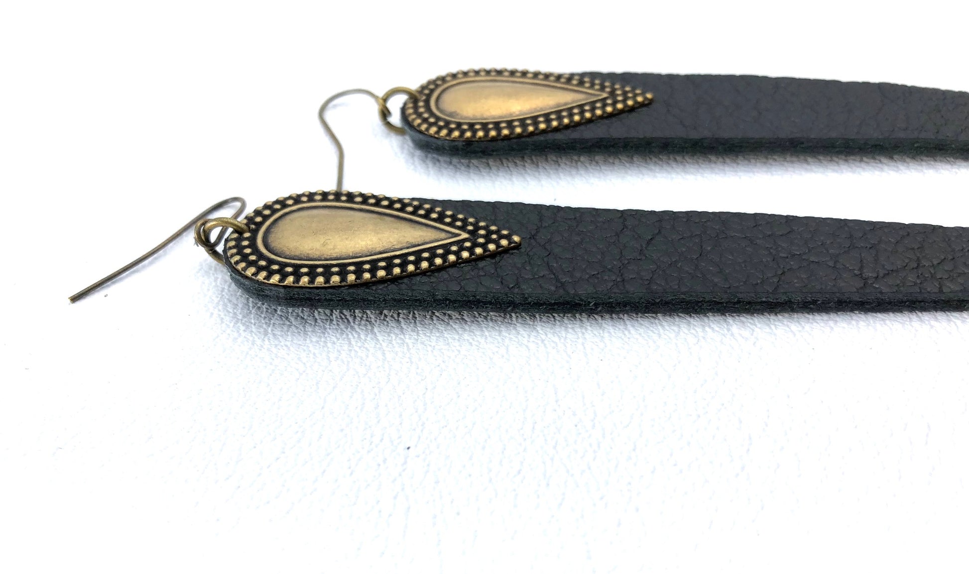 Dramatic length, leather drops.