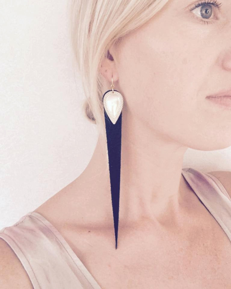 Dramatic length, leather drops.