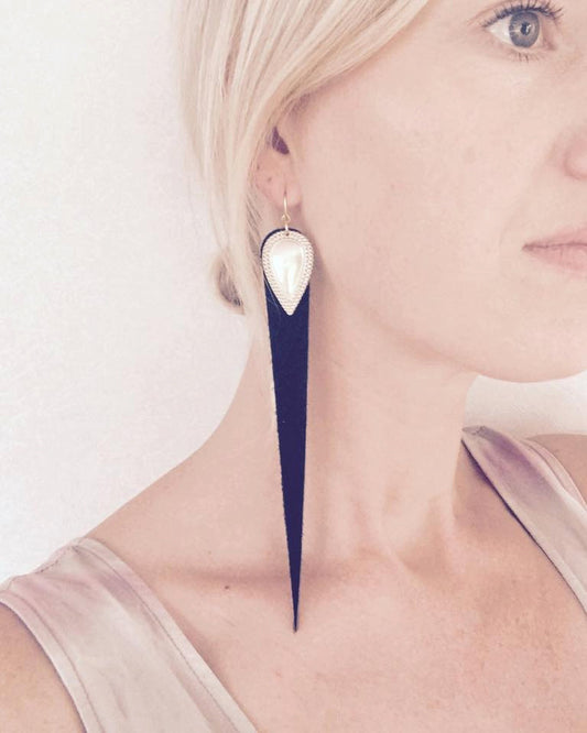 Dramatic length, leather drops.